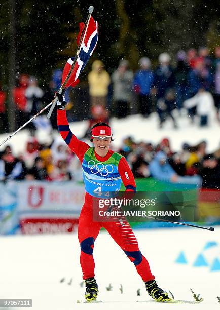 Norway's Marit Bjoergen reacts as she crosses the finish line in the women's Cross Country Skiing 4x5 km relay at Whistler Olympic Park during the...