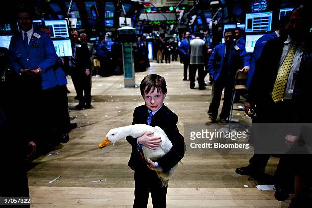 Dan Amos son of Paul Amos, president and chief operating officer of Aflac Inc., holds the Aflac Duck on the floor of the New York Stock Exchange in...