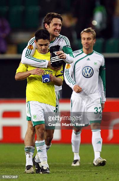Christian Gentner of Wolfsburg celebrates with team mate Josue after the UEFA Europa League knock-out round, second leg match between VfL Wolfsburg...