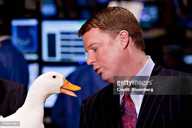 Paul Amos, president and chief operating officer of Aflac Inc., right, talks to the Aflac Duck on the floor of the New York Stock Exchange in New...