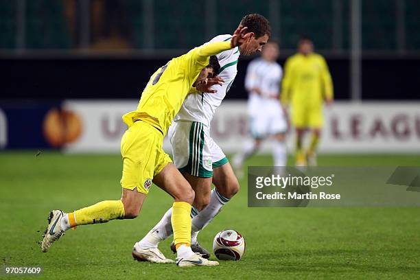 Edin Dzeko of Wolfsburg and Mateo Musacchio of Villareal compete for the ball during the UEFA Europa League knock-out round, second leg match between...