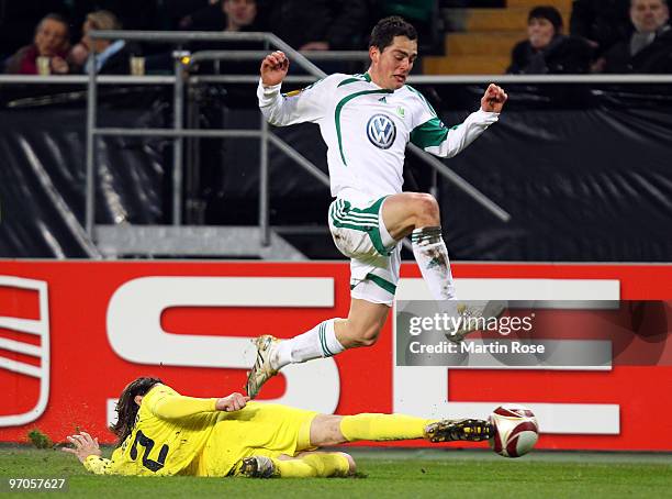 Marcel Schaefer of Wolfsburg and Gonzalo of Villareal compete for the ball during the UEFA Europa League knock-out round, second leg match between...