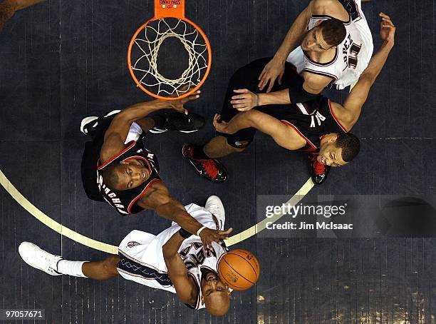 Dante Cunningham and Brandon Roy of the Portland Trail Blazers defend against Brook Lopez and Trenton Haskell at the Izod Center on February 23, 2010...