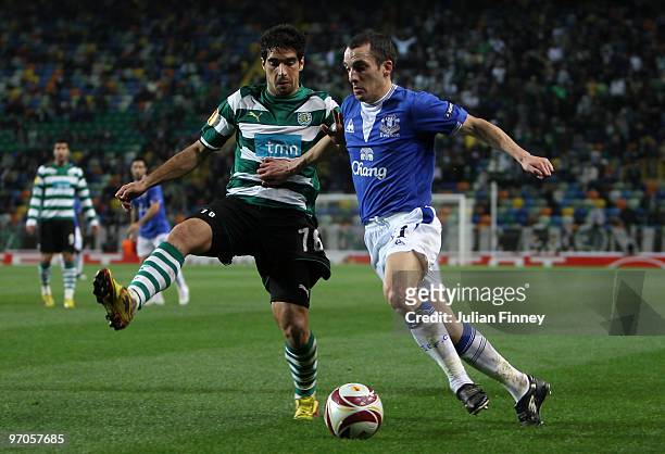 Leon Osman of Everton skips past Leandro Grimi of Sporting during the UEFA Europa League Round of 32, 2nd leg match between Sporting Lisbon and...