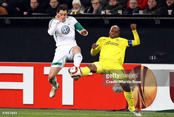 Marcel Schaefer of Wolfsburg and Marcos Senna of Villareal compete for the ball during the UEFA Europa League knock-out round, second leg match...