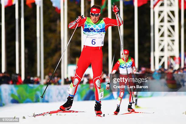 Bill Demong crosses the finish line to win the Nordic Combined Individual LH/10 km on day 14 of the 2010 Vancouver Winter Olympics at Whistler...