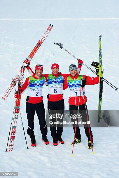 Johnny Spillane of the United States celebrates winning silver, Bill Demong of the United States gold and Bernhard Gruber of Austria bronze during...