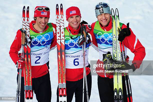 Johnny Spillane of the United States celebrates winning silver, Bill Demong of the United States gold and Bernhard Gruber of Austria bronze during...