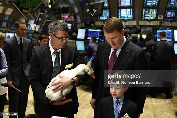 The Aflac Duck and President and COO of Aflac Paul Amos walk the trading floor during the closing bell at the New York Stock Exchange on February 25,...