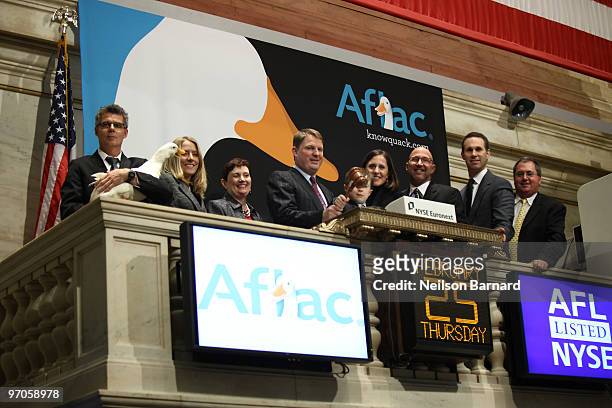 The Aflac Duck and President and COO of Aflac Paul Amos rings the closing bell at the New York Stock Exchange on February 25, 2010 in New York City.