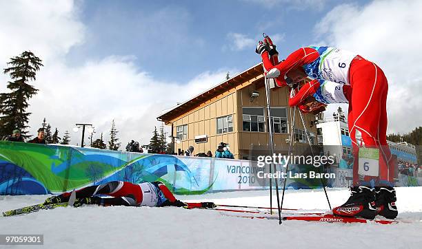 Bill Demong of the United States, Johnny Spillane of the United States and Bernhard Gruber of Austria react after crossing the finish line to win...