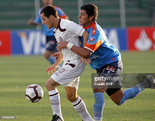 Sebastian Blanco of Argentinian Lanus vies for the ball with Omar Morales of Bolivian Blooming on February 25 during their Libertadores Cup group 4...