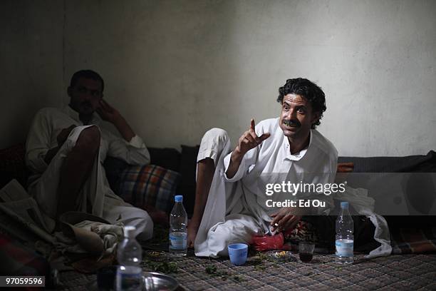 Yemeni men sit and chew at, a mild leafy narcotic in a house on June 15, 2009 in Ibb, Yemen. It is estimated that Yemenis spend 14.6 million man...