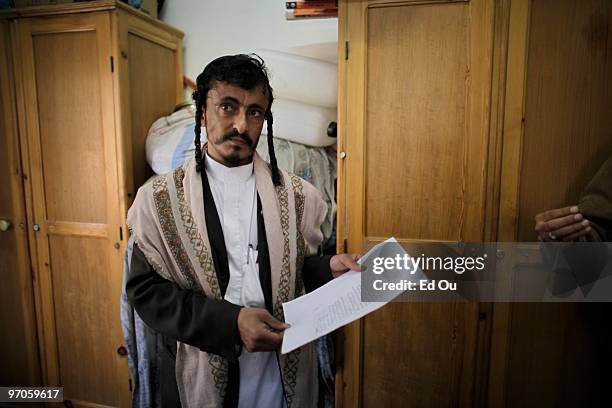 Rabbi Yahya Yusuf displays a warning letter he received, threatening him and the Jewish community in Yemen inside a protected compound in Sana'a...