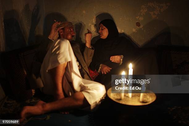 Yemeni man chews a qat, a mild leafy narcotic, while conversing with his wife in their home on June 21, 2009 in Ibb, Yemen. It is estimated that...