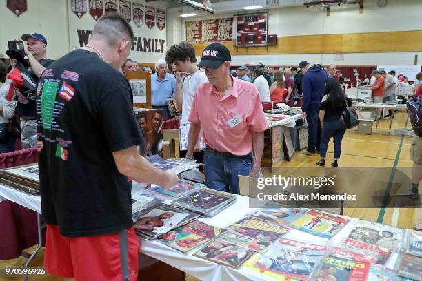Collectors and vendors are seen during the boxing card show at the International Boxing Hall of Fame for the Weekend of Champions induction events on...