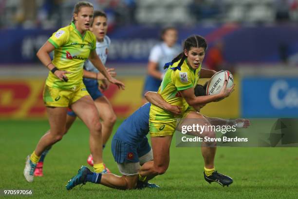 Charlotte Caslick of Australia is tackled by Chloe Pelle of France during the Women's Cup semi final between Australia and France during the HSBC...