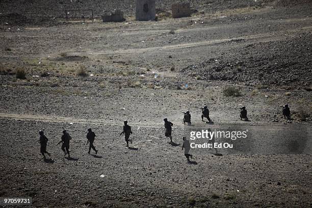 Yemeni soldiers take position in an field during a live fire counterterrorism training exercise on January 19, 2010 in Sana'a, Yemen.