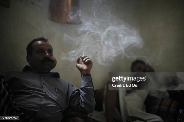 Yemeni men sit and chew qat at, a mild leafy narcotic in a house on June 15, 2009 in Ibb, Yemen. It is estimated that Yemenis spend 14.6 million man...