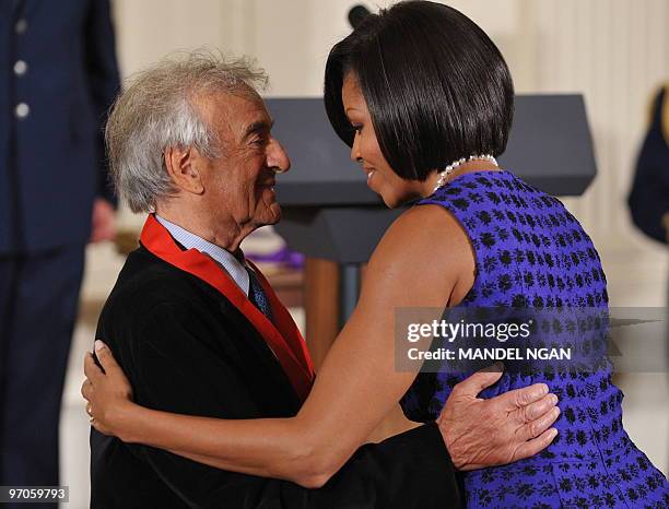 First Lady Michelle Obama congratulates Elie Wiesel after US President Barack Obama presented him with the 2009 National Humanities Medal during a...