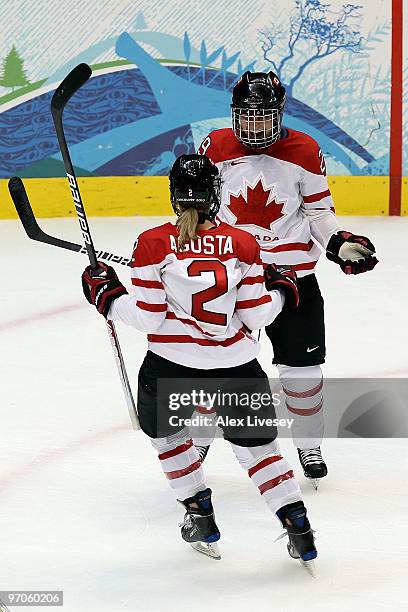 Marie-Philip Poulin of Canada celebrates with teammate Meghan Agosta of Canada after scoring a goal during the ice hockey women's gold medal game...