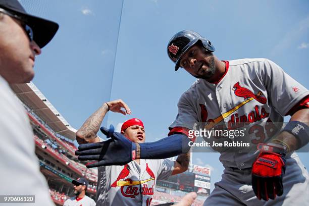 Jose Martinez of the St. Louis Cardinals celebrates with manager Mike Matheny and Carlos Martinez after hitting a solo home run in the first inning...