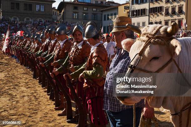 Men in traditional dress wait before the semi-final match of The Calcio Storico Fiorentino between between the Santa Maria Novella Team and Mixed...