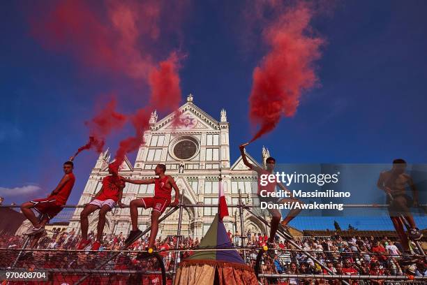 Fans of Santa Maria Novella Team let of flares before playing Mixed Team during the semi-final match of the Calcio Storico Fiorentino at Piazza Santa...