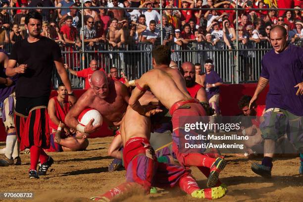 Calcianti of Santa Maria Novella Team take on Mixed Team during the semi-final match of the Calcio Storico Fiorentino at Piazza Santa Croce on June...