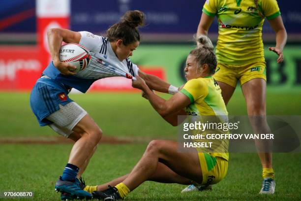 France's Camille Grassineau vies with Australia's Emma Tonegato during the Women cup rugby union 7s semi final match between Australia and France, on...
