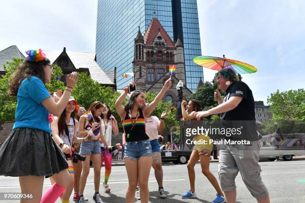 Young people dance on Boylston Street prior to the start of the 48th annual Boston Pride Parade on June 9, 2018 in Boston, Massachusetts.