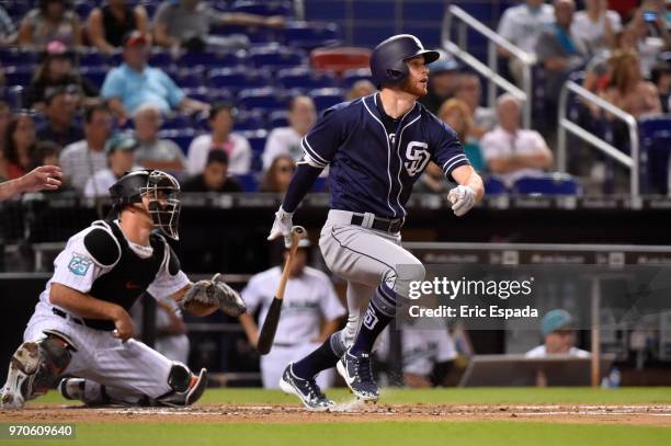 Cory Spangenberg of the San Diego Padres hits an RBI single in the first inning against the Miami Marlins at Marlins Park on June 9, 2018 in Miami,...