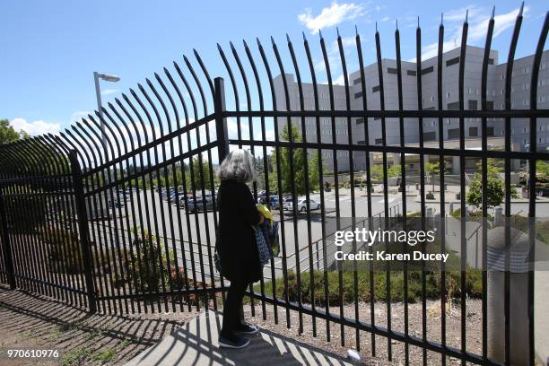 Janet Brown, from Seattle, stands outside a Federal Detention Center holding migrant women on June 9, 2018 in SeaTac, Washington. Brown participated...