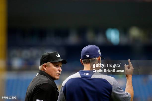 Manager Kevin Cash of the Tampa Bay Rays speaks with umpire Marvin Hudson during the fourth inning of a game against the Seattle Mariners on June 9,...