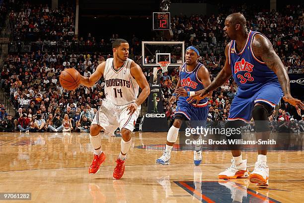 Augustin of the Charlotte Bobcats handles the ball against Daniel Gibson and Shaquille O'Neal of the Cleveland Cavaliers during the game on February...