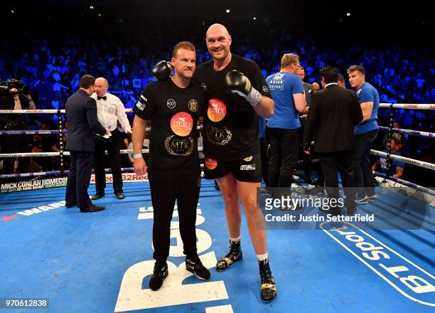 Tyson Fury and his trainer Ben Davison celebrate victory over Sefer Seferi after there heavyweight contest at Manchester Arena on June 9, 2018 in...