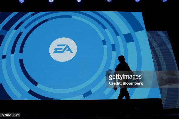 The silhouette of Andrew Wilson, chief executive officer of Electronic Arts Inc. , is seen walking off stage during the company's EA Play event ahead...