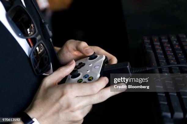 An attendee holds a Microsoft Corp. Xbox One controller while playing the Battlefield V video game during an Electronic Arts Inc. Play event ahead of...