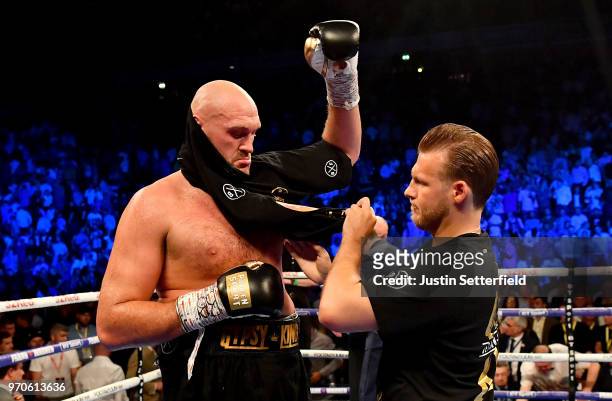 Tyson Fury and his trainer Ben Davison put his shirt on after victory over Sefer Seferi after there heavyweight contest at Manchester Arena on June...