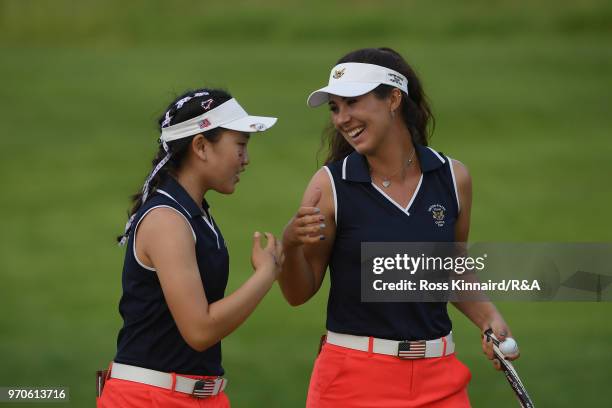 Lucy Li and Sophia Schubert of the United States team celebrate on the ninth green in their match against Paula Grant and Shannon McWilliam of the...