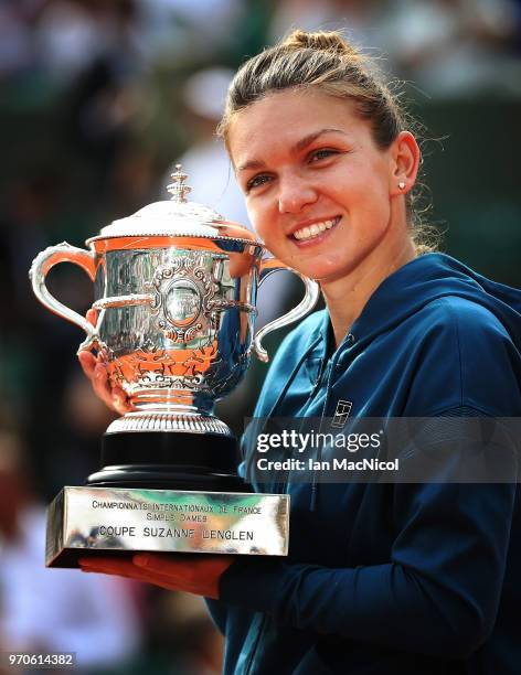 Simona Halep of Romania poses with the trophy after her Women's Singles Final match against Sloane Stephens of United States during day fourteen of...