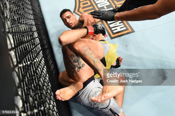 Charles Oliveira of Brazil submits Clay Guida in their lightweight fight during the UFC 225 event at the United Center on June 9, 2018 in Chicago,...