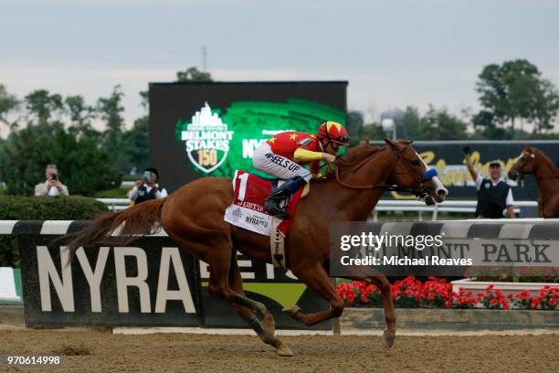 Justify, ridden by jockey Mike Smith leads the field to the finish line to win the 150th running of the Belmont Stakes at Belmont Park on June 9,...