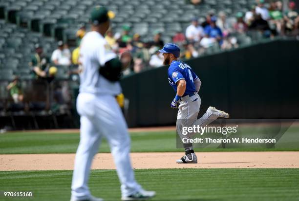 Alex Gordon of the Kansas City Royals trots around the bases after hitting a solo home run off of Yusmeiro Petit of the Oakland Athletics in the top...