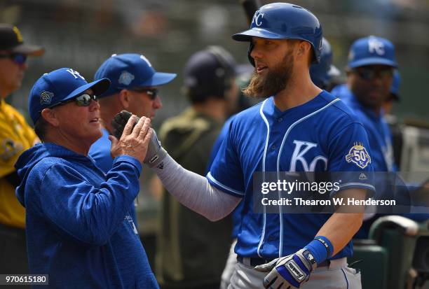Alex Gordon of the Kansas City Royals is congratulated by manager Ned Yost after Gordon hit a solo home run against the Oakland Athletics in the top...