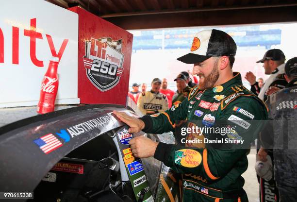 Austin Dillon, driver of the Bass Pro Shops/Cabela's Chevrolet, poses with the winner's sticker after the NASCAR Xfinity Series LTi Printing 250 at...