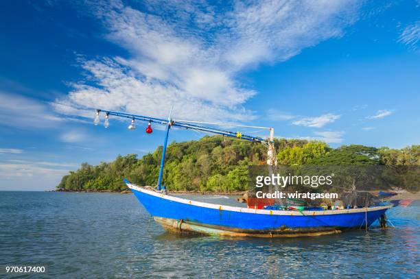 landscape of beautiful coast include in the beach with fishing boat are on the sea, blue sky and green mountain. - wiratgasem stock pictures, royalty-free photos & images