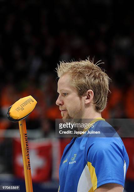 Skip Niklas Edin of Sweden holds his broom as he looks on during the men's curling semifinal game between Canada and Sweden on day 14 of the...