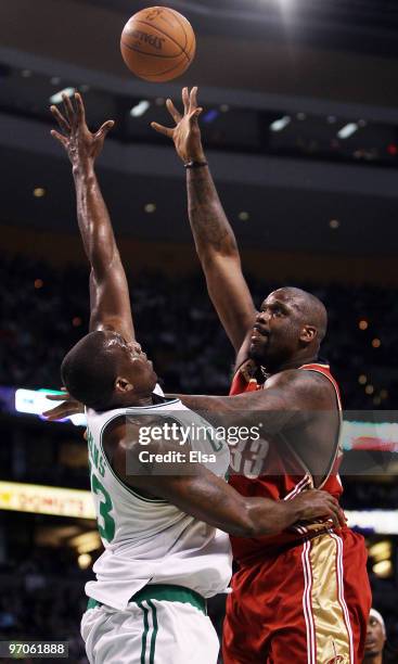 Shaquille O'Neal of the Cleveland Cavaliers takes a shot over Kendrick Perkins of the Boston Celtics in the first quarter at the TD Garden on...