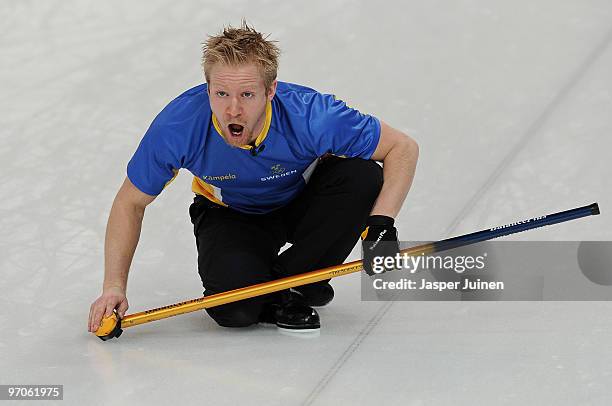 Skip Niklas Edin of Sweden reacts as he follows the stone during the men's curling semifinal game between Canada and Sweden on day 14 of the...